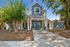 Inviting apartment exterior with charming porch, lush greenery, and bright blue double doors.