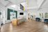Bright and welcoming office lobby with modern wood reception desk, sleek seating area, and vibrant greenery accents.