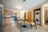 Inviting kitchen with modern appliances, wooden cabinetry, and cozy dining area, complete with an in-unit laundry setup.