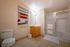 Inviting bathroom with modern tiles, stylish shower, and vibrant wall decor.