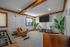 Inviting entertainment room with modern leather seating, a sleek TV setup, and vibrant indoor plants.