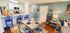 Charming open-concept dining and kitchen area with modern appliances, vibrant blue chairs, and cozy seating, perfect for a welcoming home atmosphere.