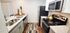 Modern kitchen with sleek stainless steel appliances, bright countertop, and stylish decor for a cozy culinary experience.