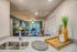 Inviting open-plan apartment with modern kitchen, stylish dining area, and cozy living room, featuring vibrant decor and abundant natural light.