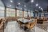 Inviting communal lounge with modern decor, featuring a large dining table, cozy seating, and expansive windows offering bright natural light.