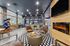 Modern lounge area with chic leather seating, contemporary decor, and a stylish coffee bar, perfect for relaxation and socializing.