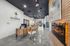 Modern and inviting lobby space at The Harbor Student Living, featuring chic wooden furniture, sleek flooring, and vibrant artwork.