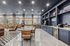 Chic communal lounge with modern seating, stylish stone walls, and sleek cabinets, creating an inviting social space.