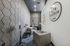 Modern studio lounge with stylish hexagonal walls, cozy seating, and professional audio equipment at The Harbor Studio.