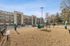 Modern apartment complex with spacious balconies, ample parking, and a well-kept outdoor play area, perfect for families and pet owners.