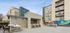 Modern apartment complex featuring stylish outdoor seating and vibrant sports mural, perfect for social gatherings and leisure.