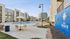 Inviting apartment complex featuring a refreshing pool, plenty of lounge chairs, and modern student living amenities at The Harbor.