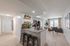 Modern open-concept apartment with a stylish kitchen island, cozy living area, and abundant natural light from floor-to-ceiling windows.