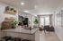 Modern open-plan apartment with sleek kitchen, cozy living area, and elegant decor, perfect for entertaining and relaxation.