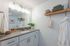 Elegant bathroom featuring modern vanity, ample storage, and stylish decor for a serene retreat.