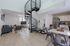 Modern apartment interior featuring a stylish spiral staircase, open-plan living room, and contemporary kitchen.