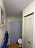 Inviting bathroom featuring elegant blue and white decor, a sleek shower curtain, and cozy towels for a refreshing experience.