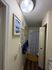 Charming bathroom with elegant decor, featuring modern blue abstract artwork, cozy patterned shower curtain, and sleek wood flooring.