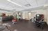 Contemporary fitness center featuring state-of-the-art equipment, free weights, and a sleek design, perfect for an invigorating workout.