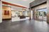 Modern lobby entrance showcasing sleek design with polished dark flooring, vibrant signage, and expansive glass doors for natural light.