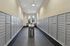 Modern mailroom with sleek metal mailboxes and natural light through large windows.