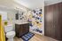 Modern bathroom with stylish vanity, vibrant abstract shower curtain, and wooden cabinets.
