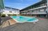 Charming apartment complex featuring a sparkling outdoor pool and modern three-story architecture.