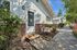 Inviting entrance to The Vicinity leasing office, surrounded by lush greenery and a well-maintained walkway.