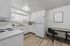 Bright, modern kitchen with sleek white cabinetry, spacious countertops, and a cozy dining nook.