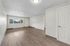 Bright and spacious living area with modern flooring and large windows inviting natural light.