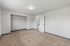 Bright and spacious bedroom featuring soft carpet flooring, a large closet, and modern lighting.