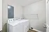 Contemporary laundry room with modern washing machine and dryer, featuring a sleek design and ample storage space.