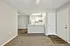 Chic open-concept apartment with elegant kitchen, modern cabinetry, and inviting carpet flooring.