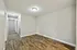 Bright and inviting hallway and room with elegant hardwood flooring, featuring modern lighting and a neutral color palette, perfect for a chic and cozy home ambiance.