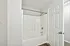Bright and inviting bathroom with sleek tub and modern fixtures, perfect for relaxation.