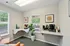 Charming corner refreshment area with cozy seating, a coffee station, and vibrant decor, perfect for relaxation and conversation.