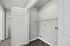 Bright and modern laundry area with sleek hardwood flooring and convenient wall shelving.