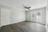 Bright, open living space with sleek wood floors, fresh neutral walls, and double glass doors, ideal for modern living.