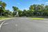 Inviting community area with lush greenery and a charming playground, perfect for family enjoyment.