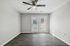 Bright, modern room with sleek wood flooring and large double doors opening to a scenic view.