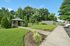 Charming garden view with a picturesque gazebo surrounded by lush greenery, perfect for relaxing and enjoying nature.