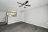 Modern living space featuring an open layout with stylish flooring, recessed lighting, and a ceiling fan, adjacent to a contemporary kitchen with elegant cabinetry.
