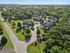 Inviting aerial view of a lush, green apartment community with well-maintained buildings, ample parking, and serene surroundings.