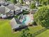 Charming apartment complex with a refreshing outdoor pool, surrounded by lush greenery and ample parking, offering a perfect blend of relaxation and convenience.