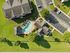 Aerial view of a beautifully landscaped apartment complex featuring a sparkling swimming pool, sunbathing area, and ample parking, surrounded by lush green lawns.