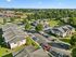 Aerial view of a serene apartment community featuring landscaped green spaces, ample parking, and well-maintained building exteriors.