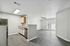 Modern, open-concept kitchen and living area with sleek flooring, ample natural light, and stylish finishes.