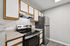 Modern kitchen with sleek stainless steel appliances, elegant countertops, and ample storage space in an inviting neutral color scheme.