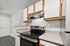 Modern kitchen featuring sleek countertops, a stainless steel oven, and ample cabinet space with elegant wooden accents.