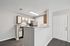 Modern kitchen with sleek countertops, stainless steel appliances, and stylish cabinetry, perfect for culinary enthusiasts.